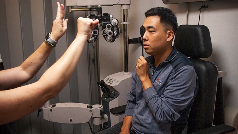 Indoor photo of a man taking an eye exam